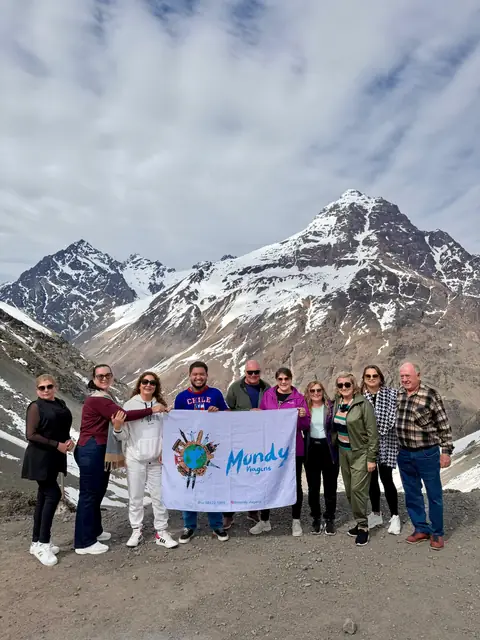 Grupo da Mundy com a bandeira diante da Cordilheira dos Andes